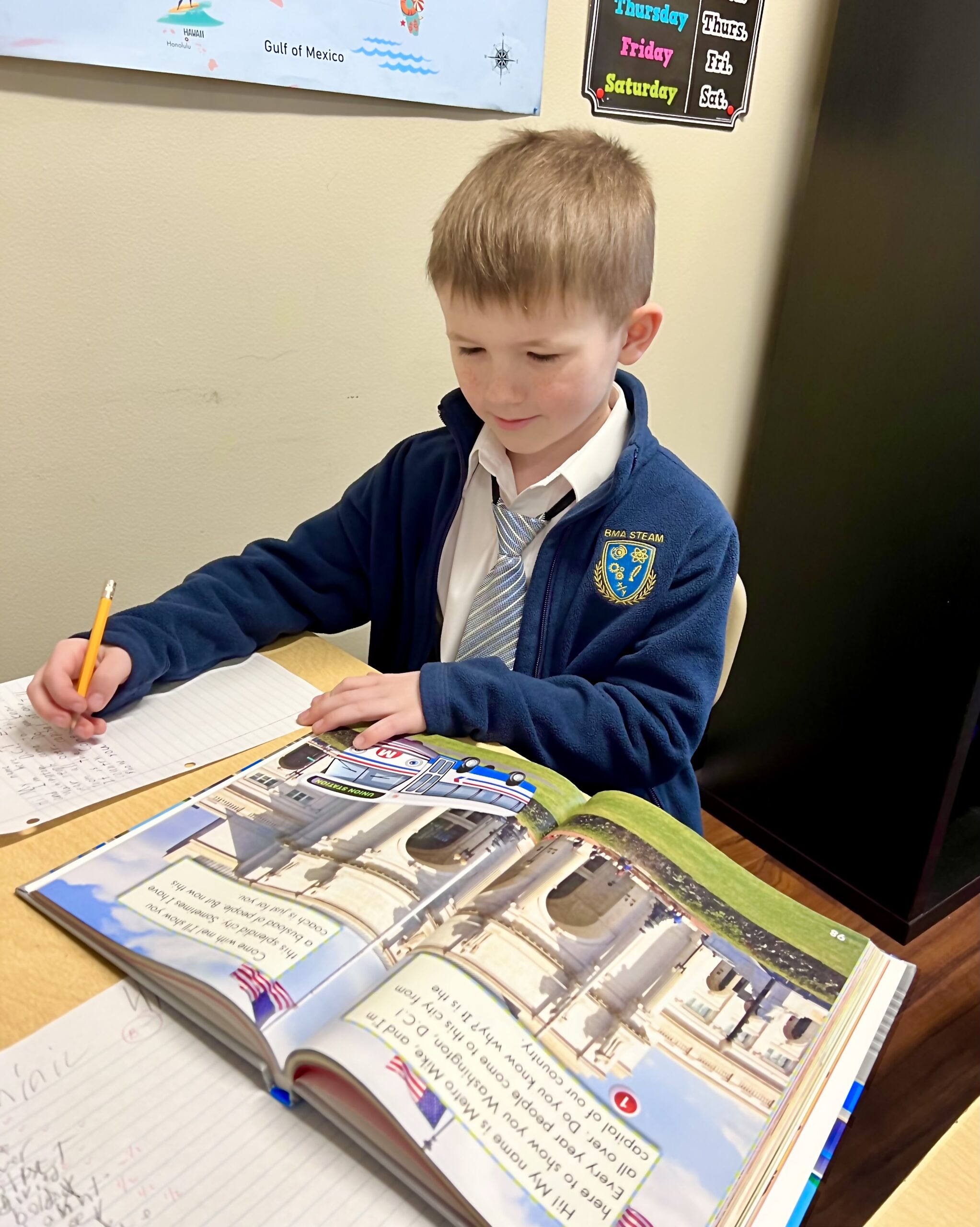 Lower School student is writing and reading