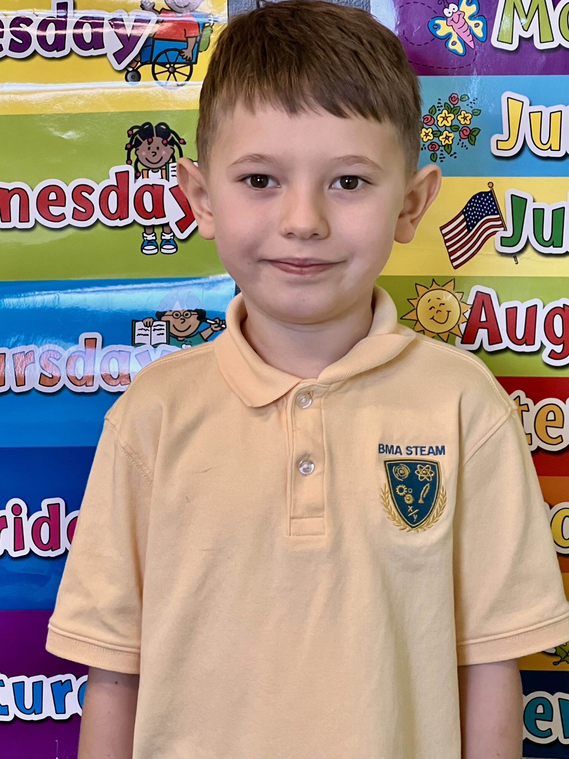 Blooming Minds STEAM Academy student wearing the official maize polo with school logo